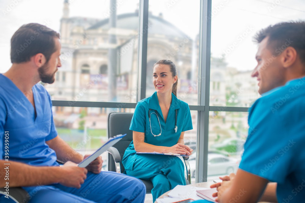 Fototapeta premium Medical workers discussing working issues and looking involved