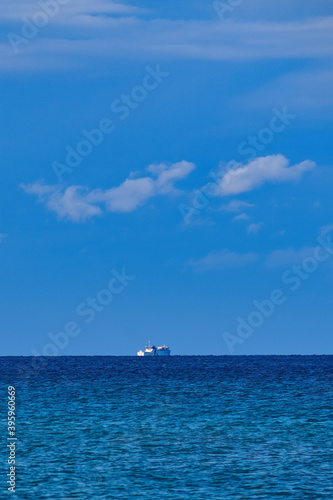 Ferry ship on the horizon from the beach of Castagneto Carducci Tuscany Italy