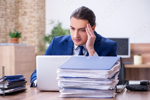 Young male employee unhappy with excessive work