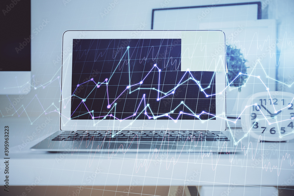 Double exposure of chart and financial info and work space with computer background. Concept of international online trading. Double exposure of chart and financial info and work space with computer background. Concept of international online trading.