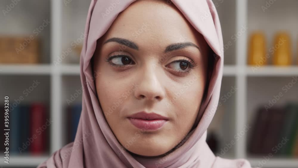 Close-up portrait of young and attractive muslim girl in hijab. Middle Eastern woman is sitting in front of the camera. Close-up portrait of young and attractive muslim girl in hijab. Middle Eastern woman is sitting in front of the camera.