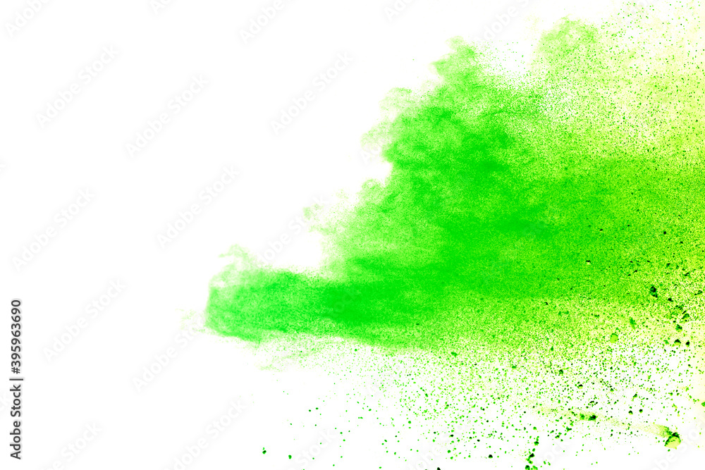Freeze motion of green color powder exploding on white background.