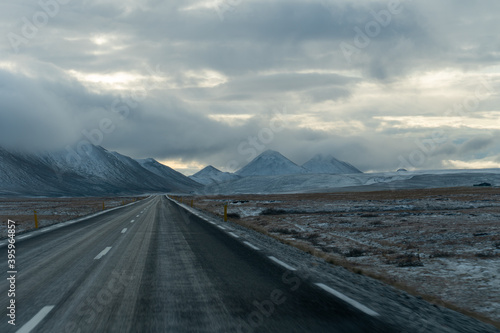 Typical icelandic road with black mountains in background