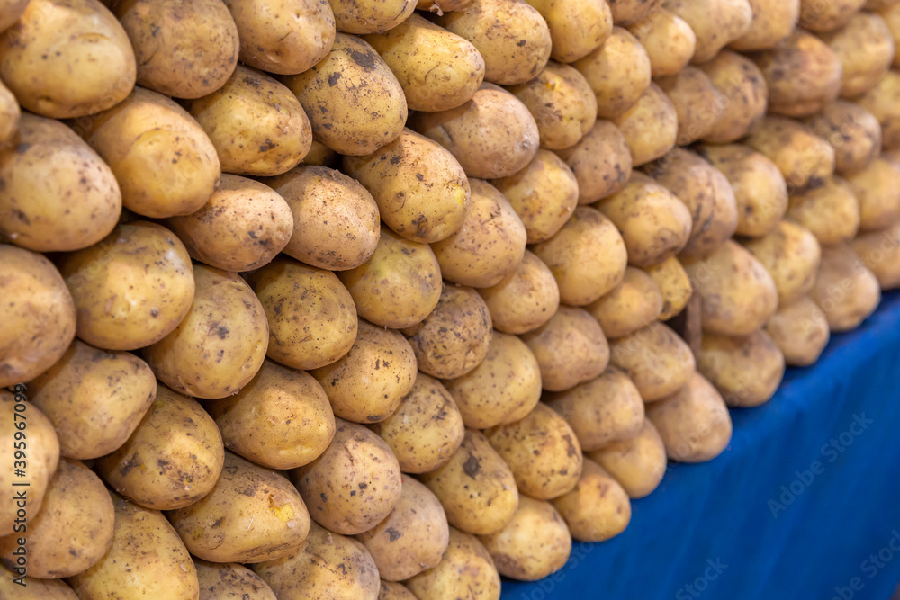 Close-up, potatoes standing in a row on the counter in the marketplace Close-up, potatoes standing in a row on the counter in the marketplace