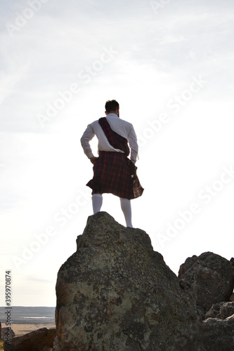 businessman on top of a mountain