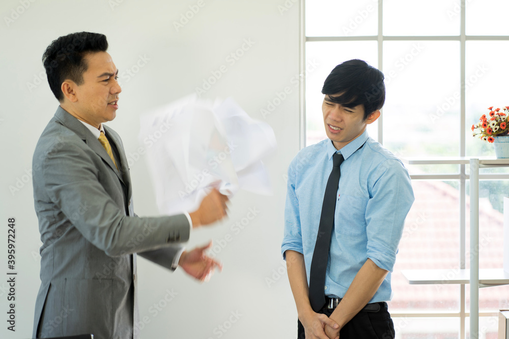 business man feeling desperate worry and upset by financial problem in the office with employee work from home new normal. business man feeling desperate worry and upset by financial problem in the office with employee work from home new normal.