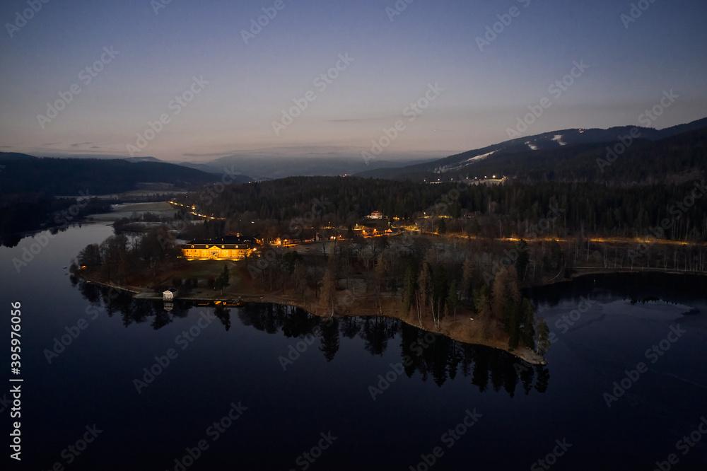 Drone or aerial photo from Oslo, Norway. Shot in late November in blue hours. Winter is coming. Ground and trees are covered with snow frost, the lakes are freezing up. Drone or aerial photo from Oslo, Norway. Shot in late November in blue hours. Winter is coming. Ground and trees are covered with snow frost, the lakes are freezing up.