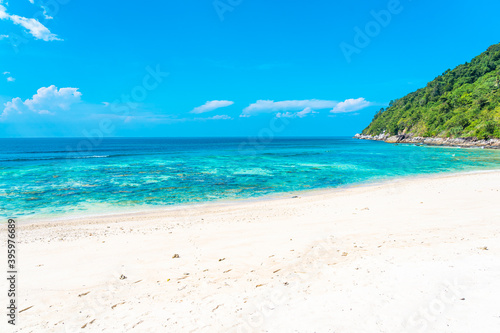 Fototapeta Naklejka Na Ścianę i Meble -  Beautiful tropical beach sea ocean with coconut and other tree around white cloud on blue sky