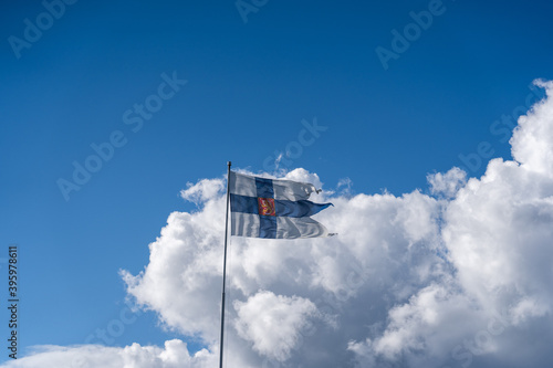 Finland’s flag with the lion flying in the hard wind on a sunny day
