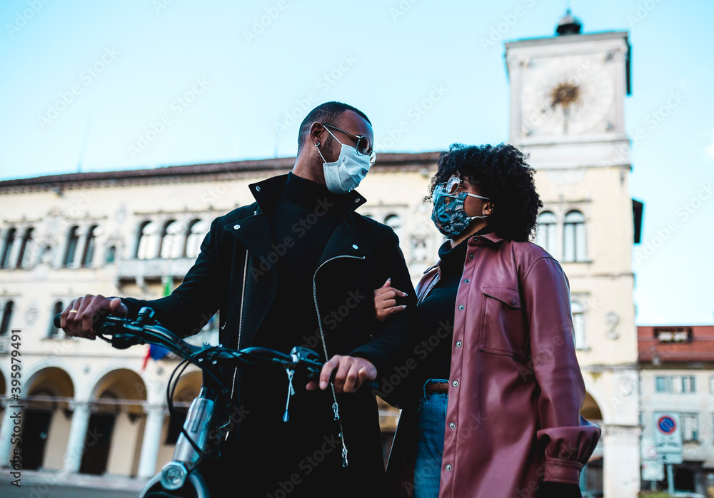Portrait of couple with face mask and bicycle.