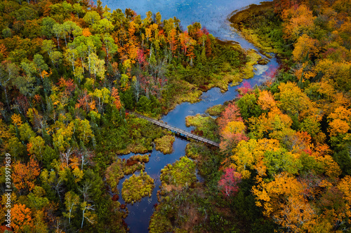 Beautiful travel aerial looking down at Carp River where it connects with Lake of the Clouds on top of Porcupine Mountain in Upper Michigan with gorgeous colorful fall leaf foliage in autumn.
