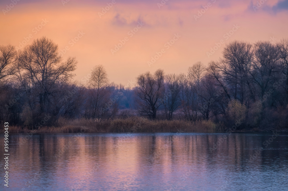 Island on the river in winter. Cold sunrise

