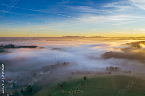 sun rise in the Bavarian forest with fog swathes in pastel colours