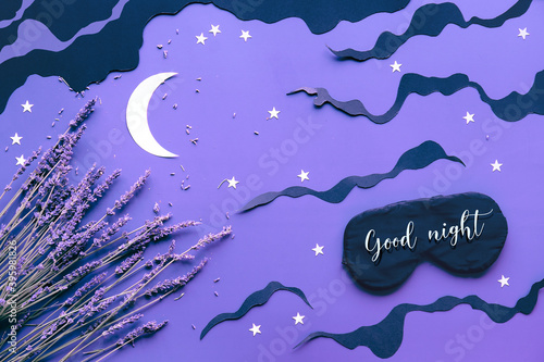 Sleep mask with lavender on purple color background with black clouds, Moon and stars. Text Good night on the mask. Quality of sleep, aromatherapy, scented herbal remedies. Creative flat lay.
