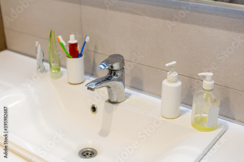 Fotografija Old dirty washbasin with rust stains, limescale and soap stains in the bathroom with a faucet, water tap
