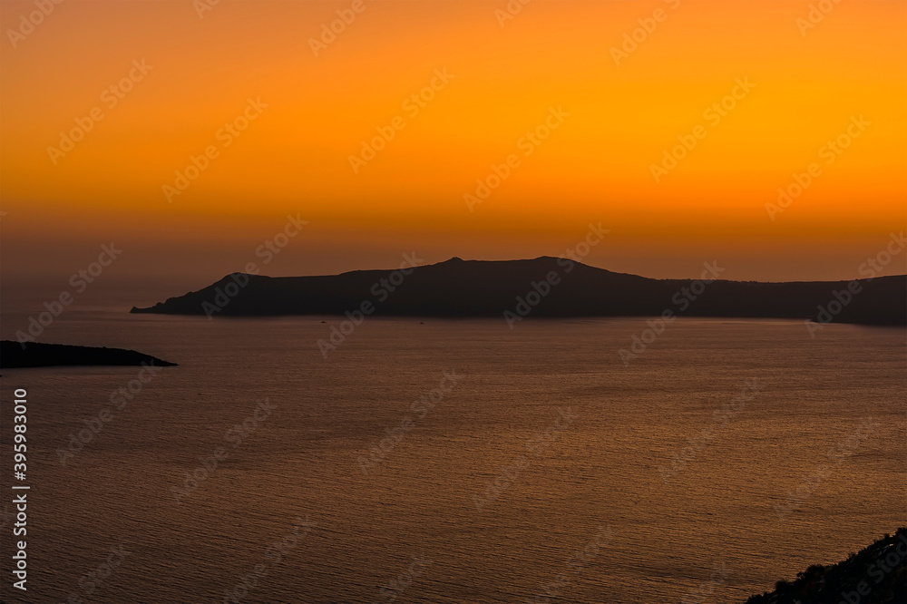 A view across the caldera after sunset from Thira, Santorini in summertime