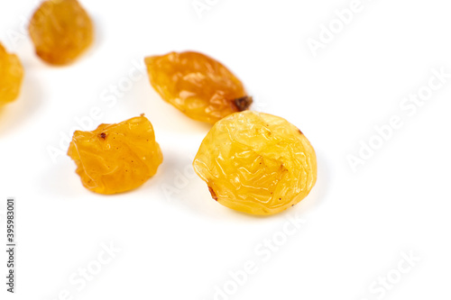 Dried yellow raisins on white background. Close up photo.