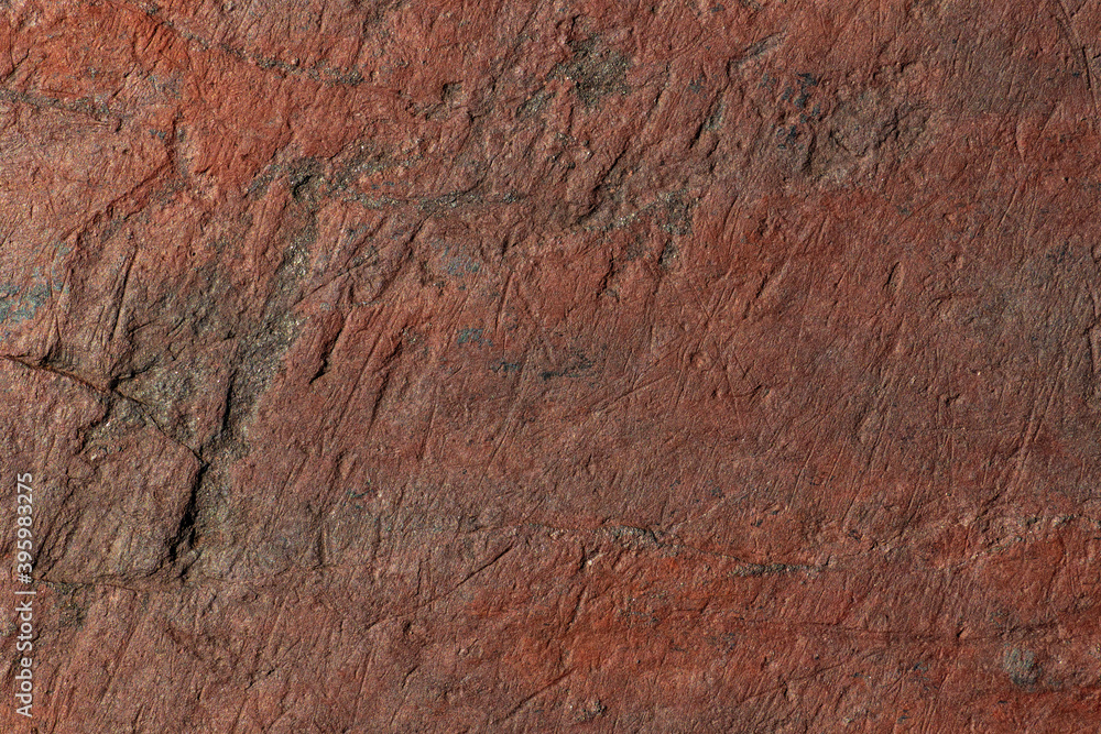 Dark red wall abstract natural stone texture. Background for packaging and design. Stone wall pattern.