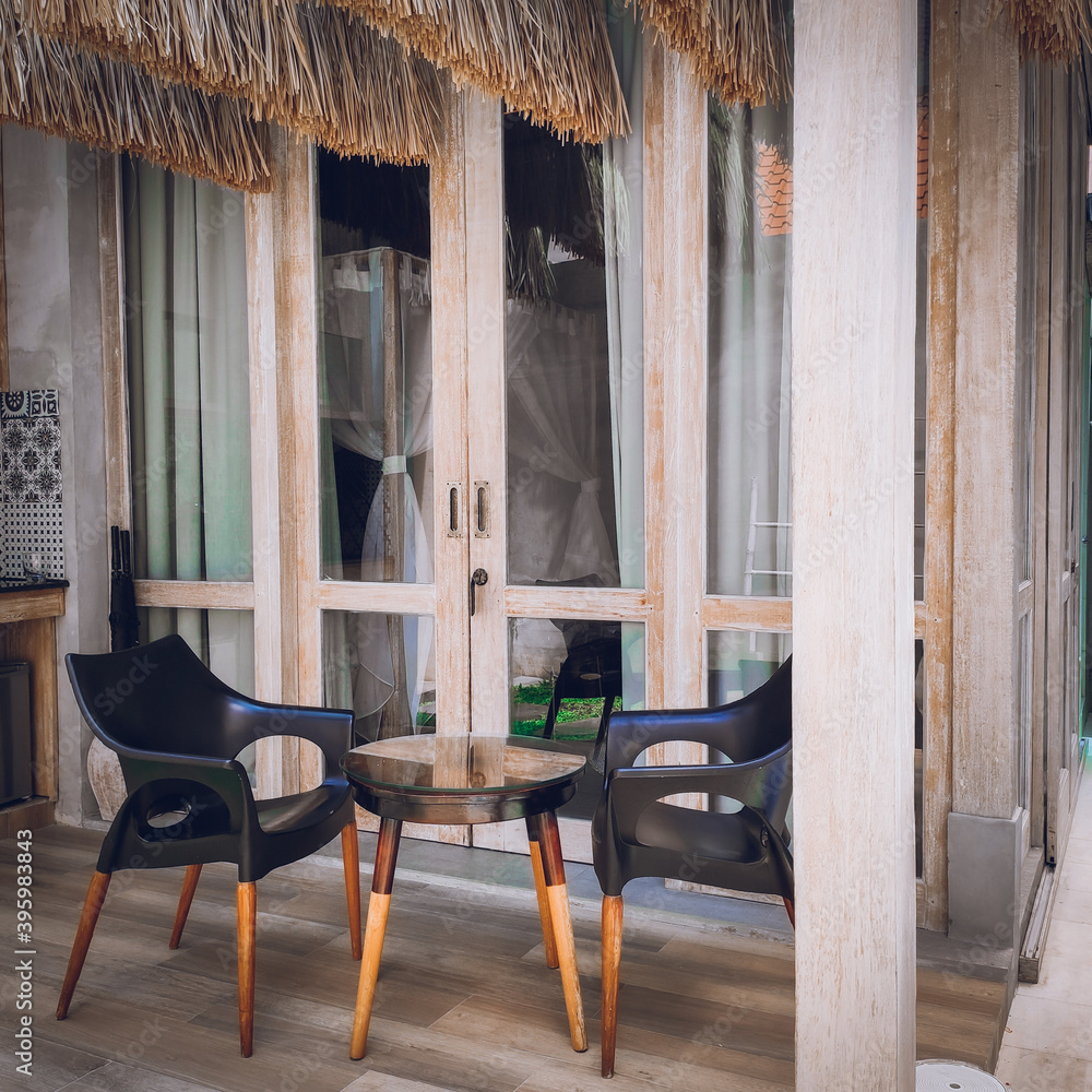 Outdoor area of a classic villa with chairs and tables Outdoor area of a classic villa with chairs and tables