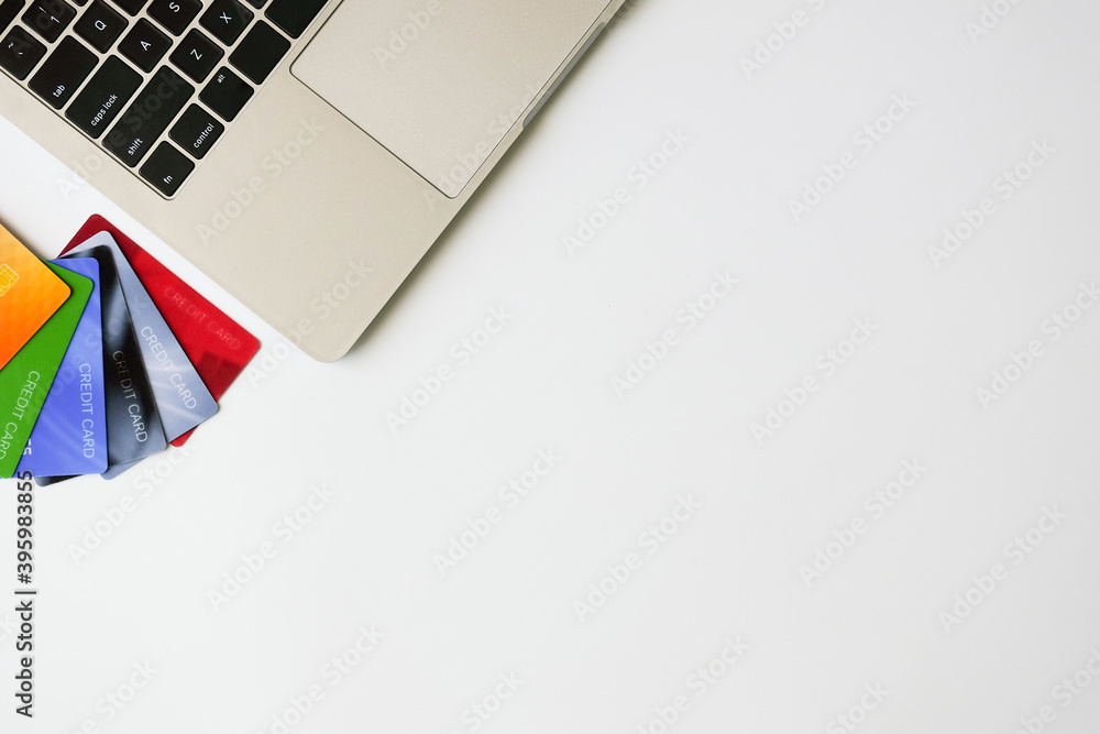 Fototapeta premium Top view laptop and credit cards with copy space. Shopping online concept. Flat lay.