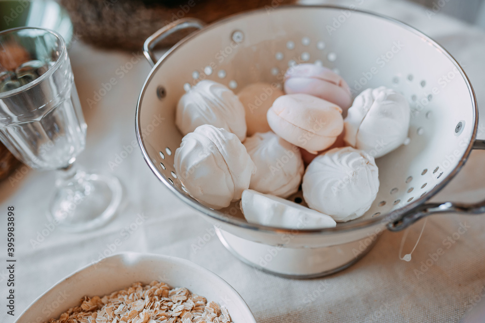 Christmas decorations. White and pink marsh-mallows inside white bowl on wooden table. Christmas decorations. White and pink marsh-mallows inside white bowl on wooden table.