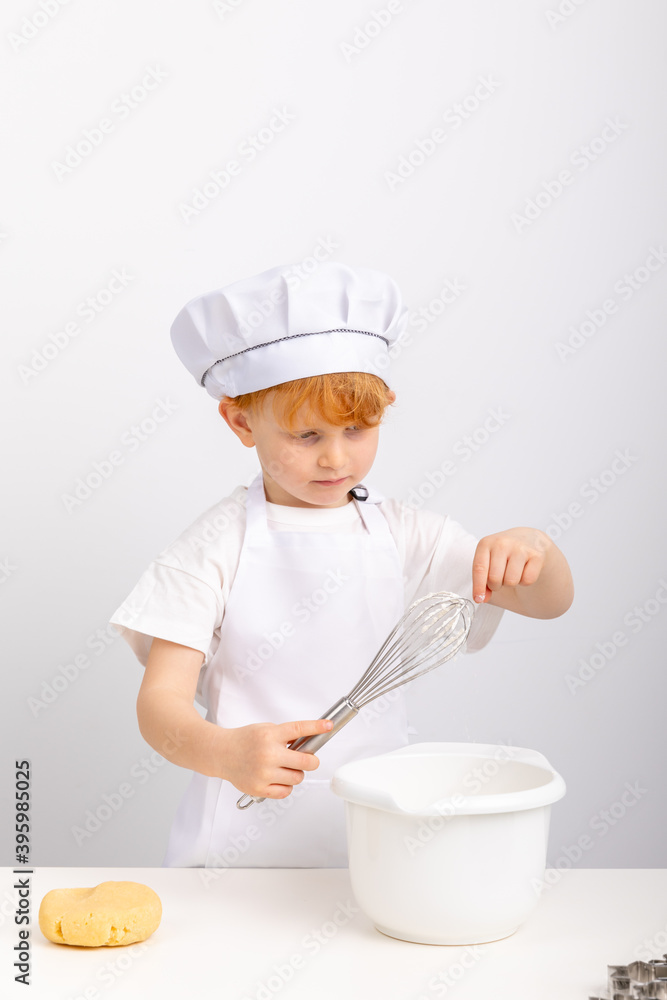 Junge mit roten Haaren hat Spaß beim Plätzchen backen. Junge mit roten Haaren hat Spaß beim Plätzchen backen.