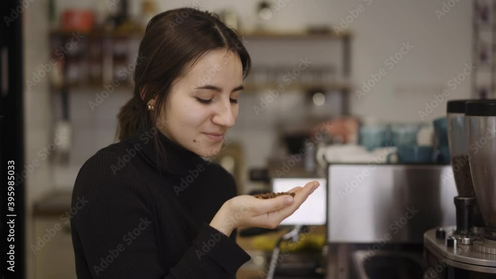 the barista enjoys the smell of roasted coffee beansat in cafe the barista enjoys the smell of roasted coffee beansat in cafe