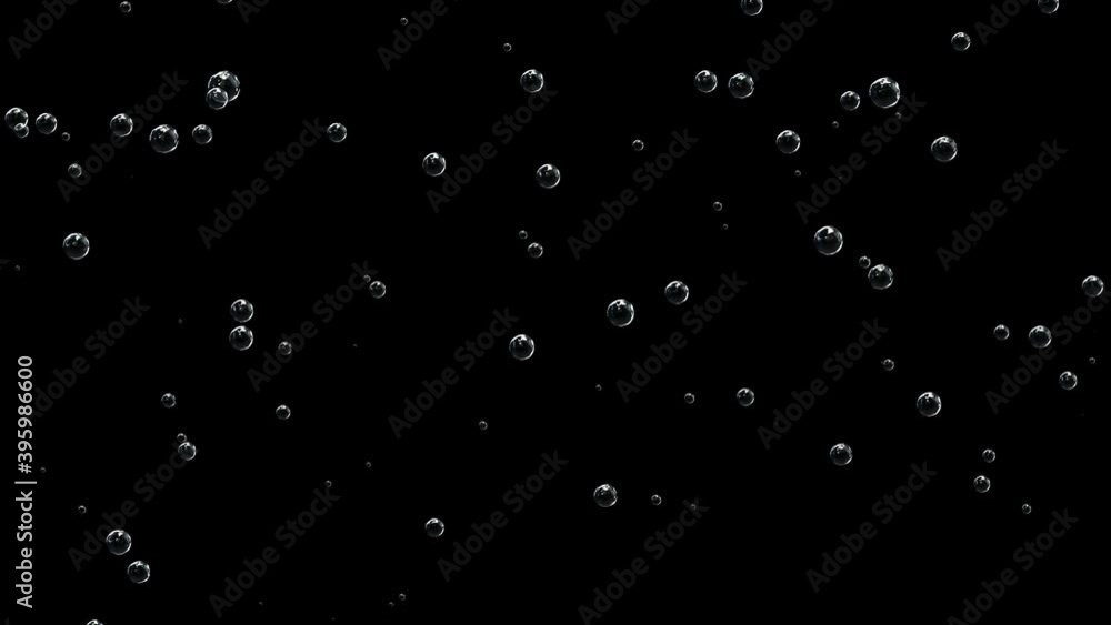 Bubbles of champagne on a black background rise. Bubbles of champagne on a black background rise.