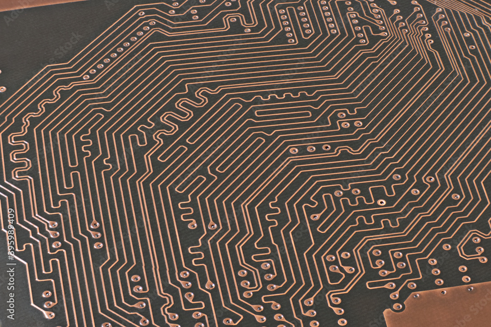 Brown printed circuit board with a lot of traces macro shot with high depth of field. Conductive traces and through-hole vias on pcb. Brown printed circuit board with a lot of traces macro shot with high depth of field. Conductive traces and through-hole vias on pcb.