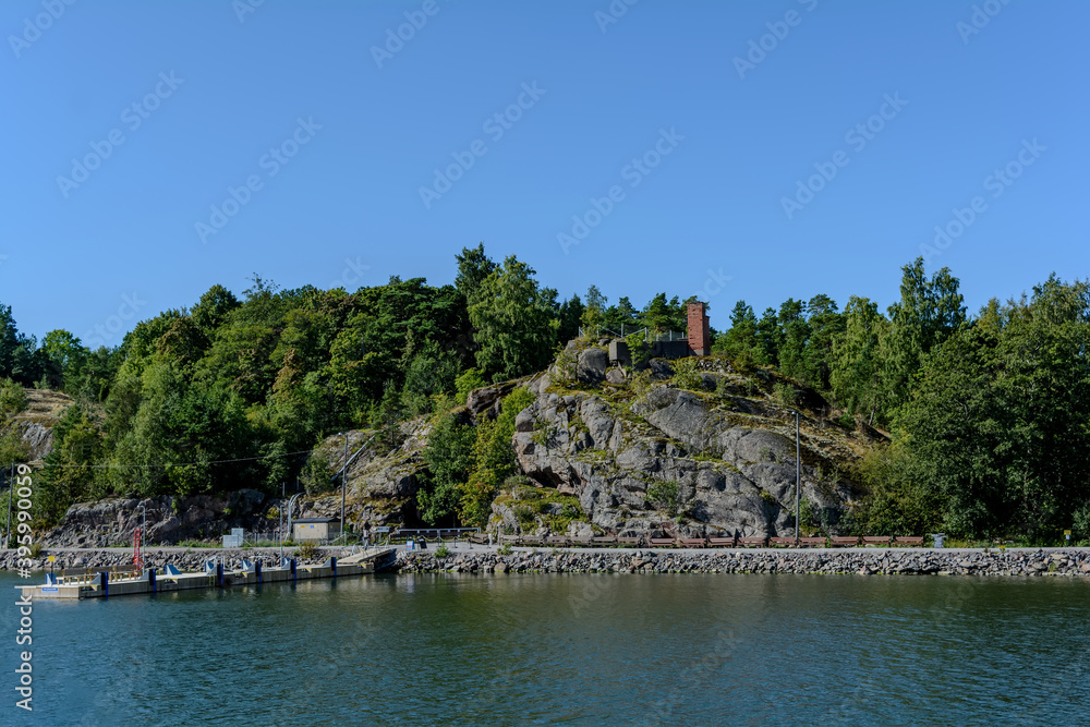 Pier and rocks of small Vallisaari island located between Helsinki and Suomenlinna. Despite small size there are fortifications, buildings, and a record-breaking range of species.