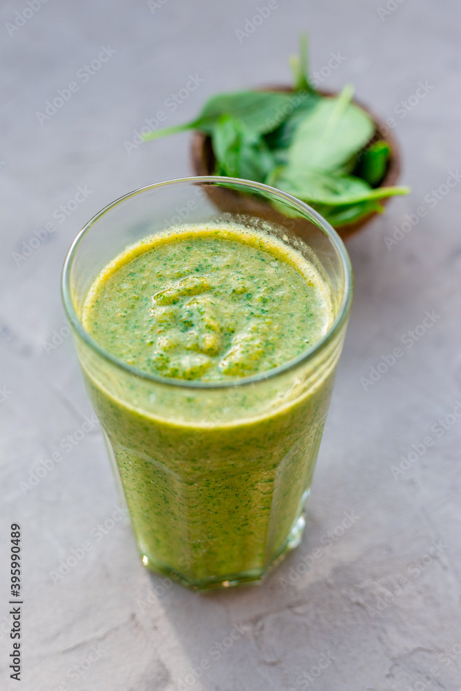Healthy green smoothie with spinach in a glass mug, drink banner Healthy green smoothie with spinach in a glass mug, drink banner