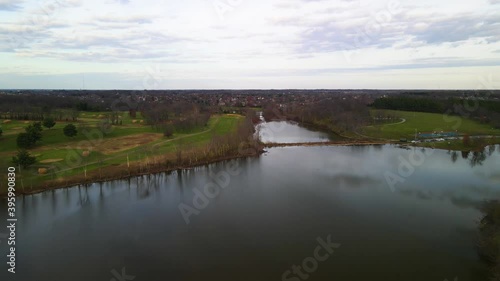 Flying over Jacobson Park Lake toward city of Lexington, Kentucky photo