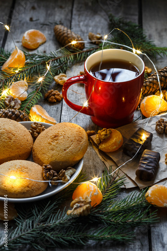 Cup of tea with cookies, wooden table, sweets