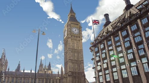 Time lapse of big ben tower or clock during a sunny cloudy day. There is the tower in close up and the clouds in background