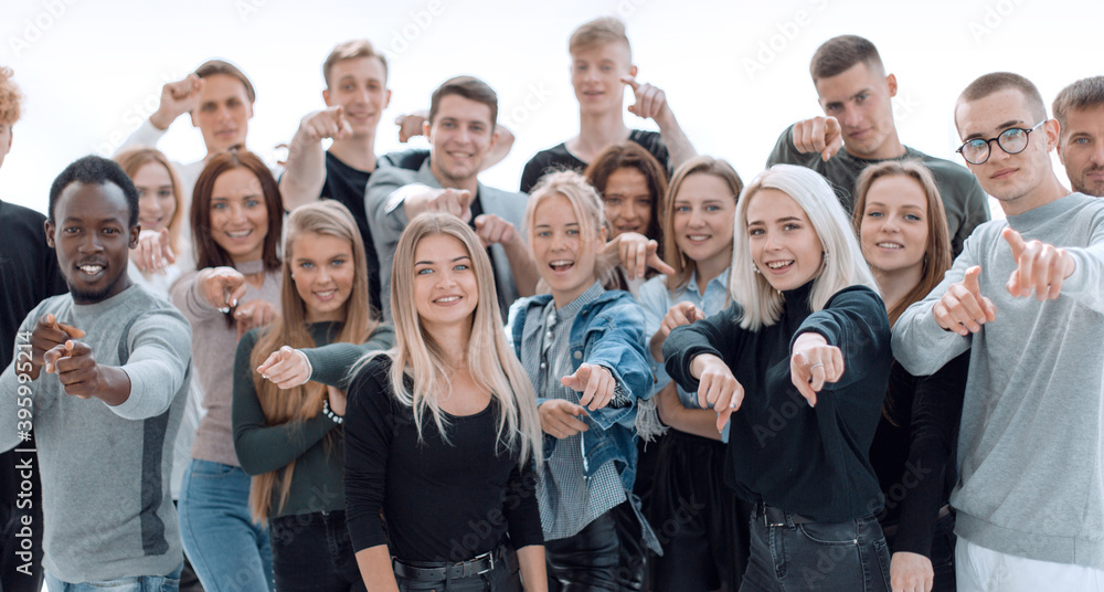 group of happy young people pointing at you.