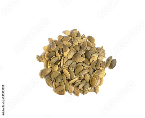 peeled raw pumpkin seeds on a white background