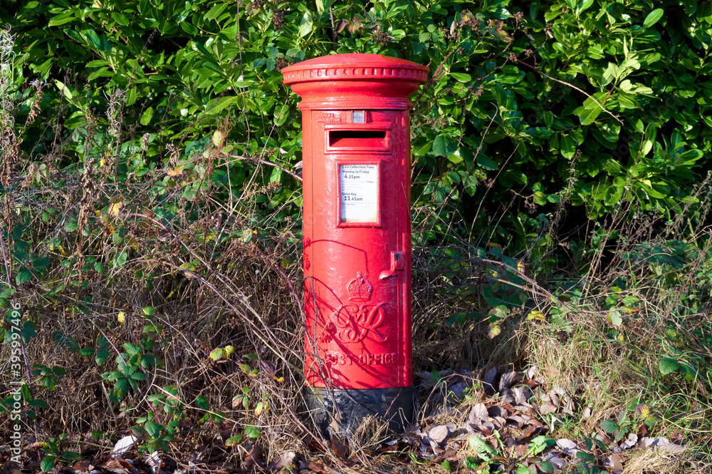 Red post box in rural countryside in England