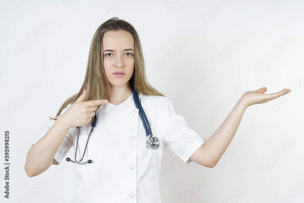 Medicine and health concept. Doctor pointing with his hands to the side and looking at the camera. Medicine and health concept. Doctor pointing with his hands to the side and looking at the camera.