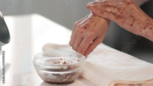 Close up of scrubbing unrecognizable female hands with grapefruit and coffee moisturizing scrub with coconut oil taking care of skin
