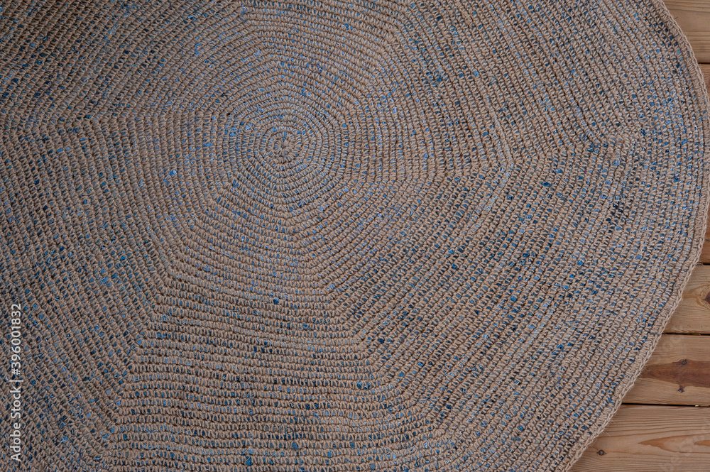 Fototapeta premium dark vintage round rug on wooden floor top view close up