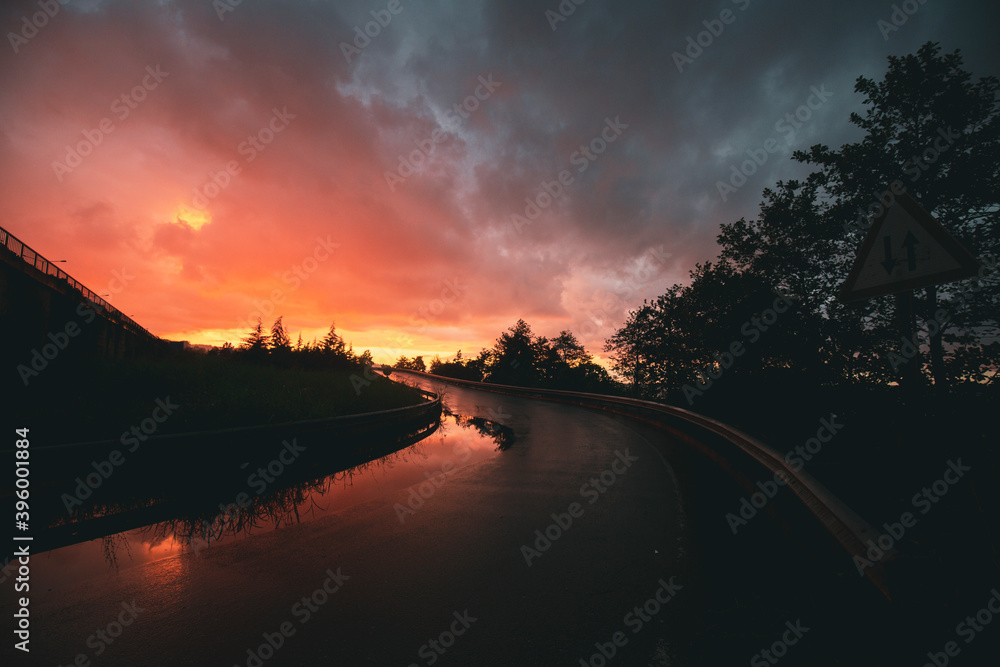 wet reflected road in sunset wet reflected road in sunset