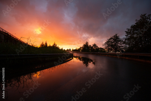 wet reflected road in sunset