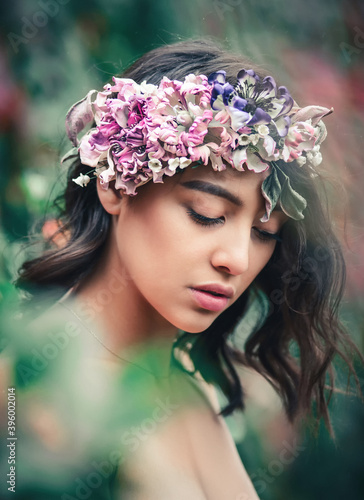 Beautiful romantic woman with flower wreath outdoor beauty portrait