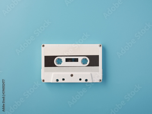White audio cassette on blue background