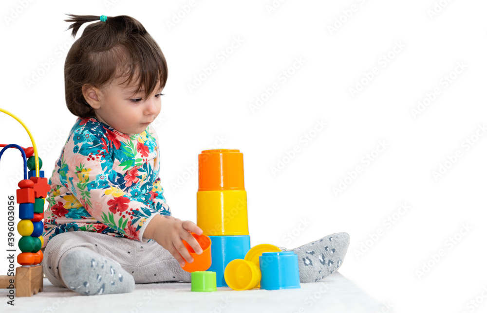 Baby girl playing with educational blocks with white isolated background Baby girl playing with educational blocks with white isolated background