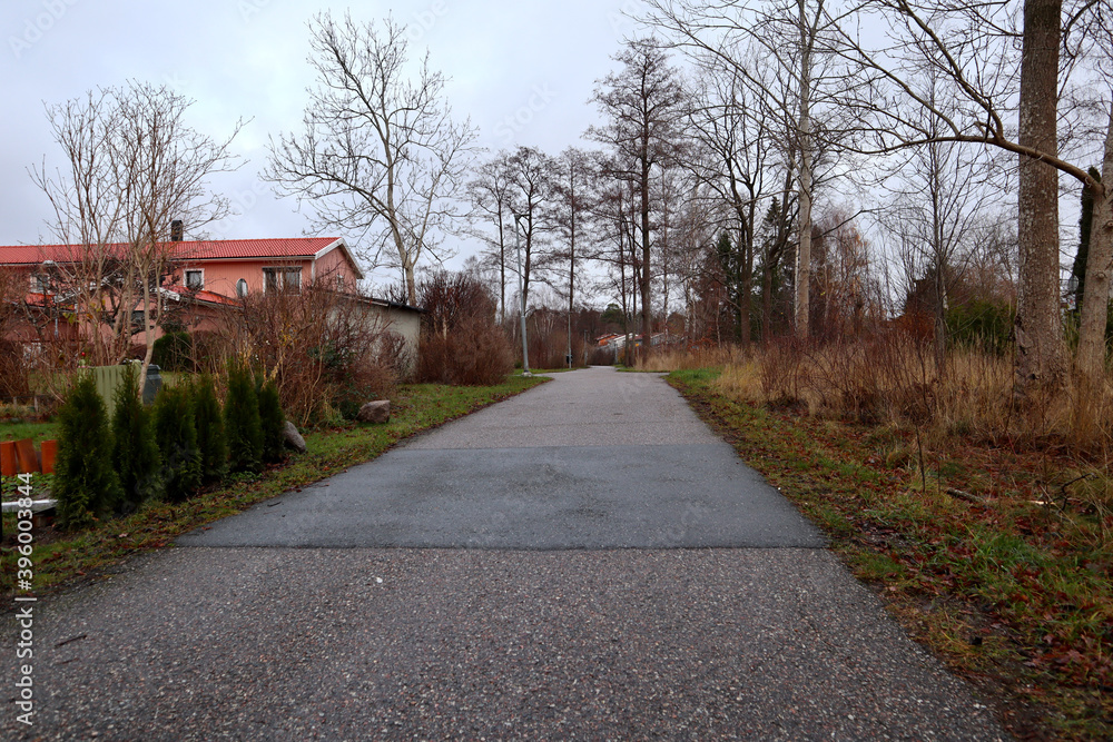 Another random Swedish road at an urban area. One street for walking. Gray day outside with plenty of clouds in the gray sky. Järfälla, Stockholm, Sweden.