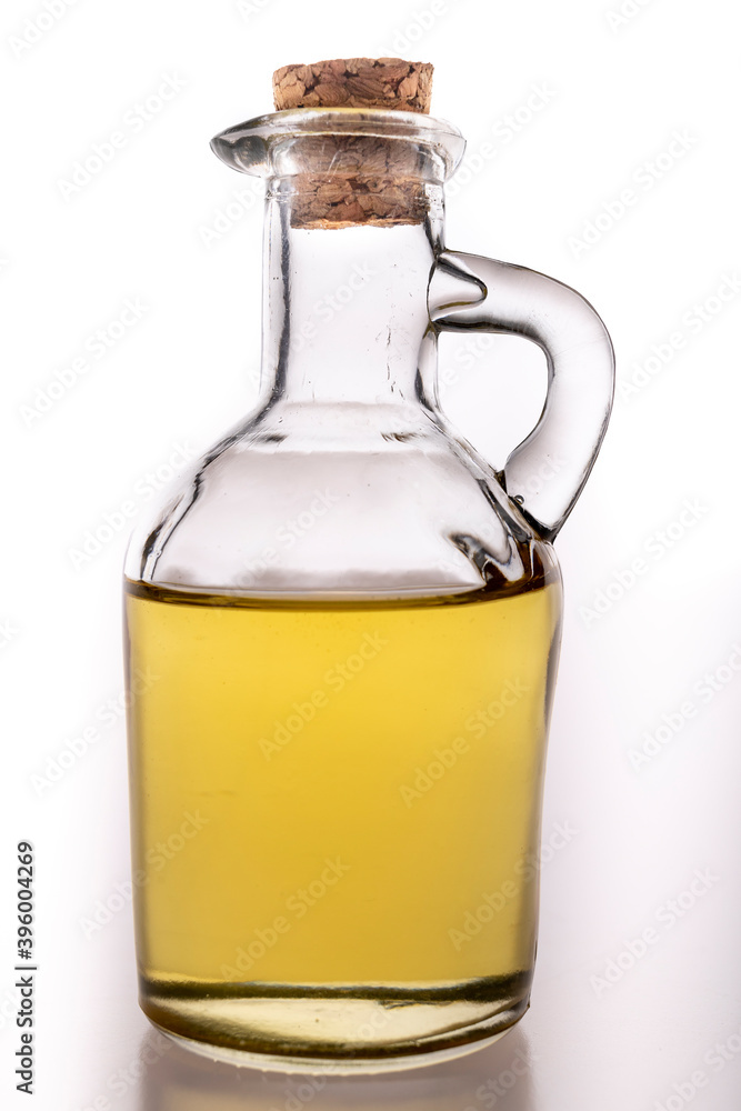 Oil in a glass container with a stopper. A jug of olive oil used in the household.