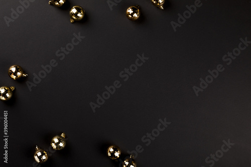 Christmas composition gold balls on a black background. Decorations for the New Year.