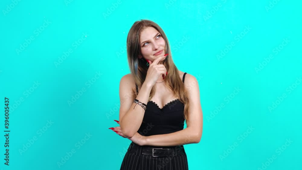 Suspended teenager, finally disappointed by the news she received. Charming girl, dressed in black T-shirt with cleavage, in the studio on a blue background. female casting for TV commercial, student Suspended teenager, finally disappointed by the news she received. Charming girl, dressed in black T-shirt with cleavage, in the studio on a blue background. female casting for TV commercial, student