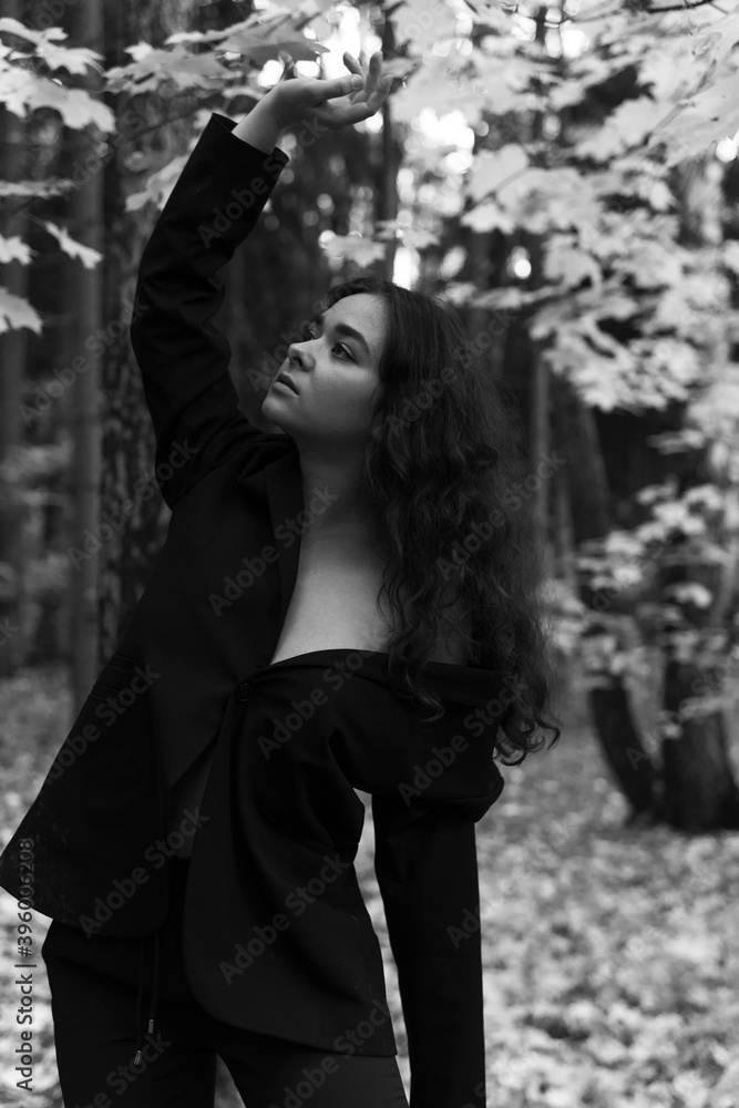 
beautiful brunette in a jacket in the forest
